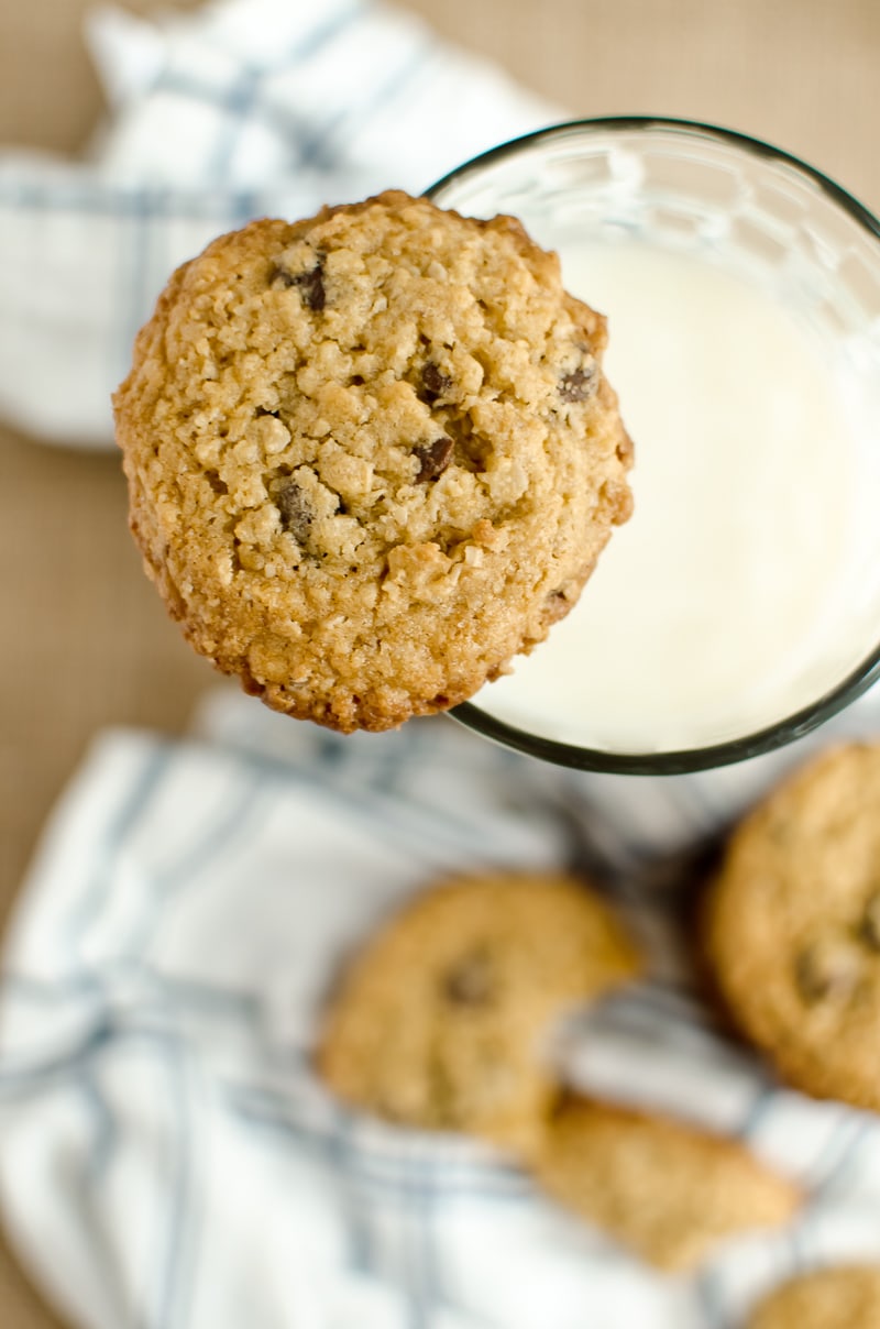 oatmeal chocolate chip cookies resting on glass of milk